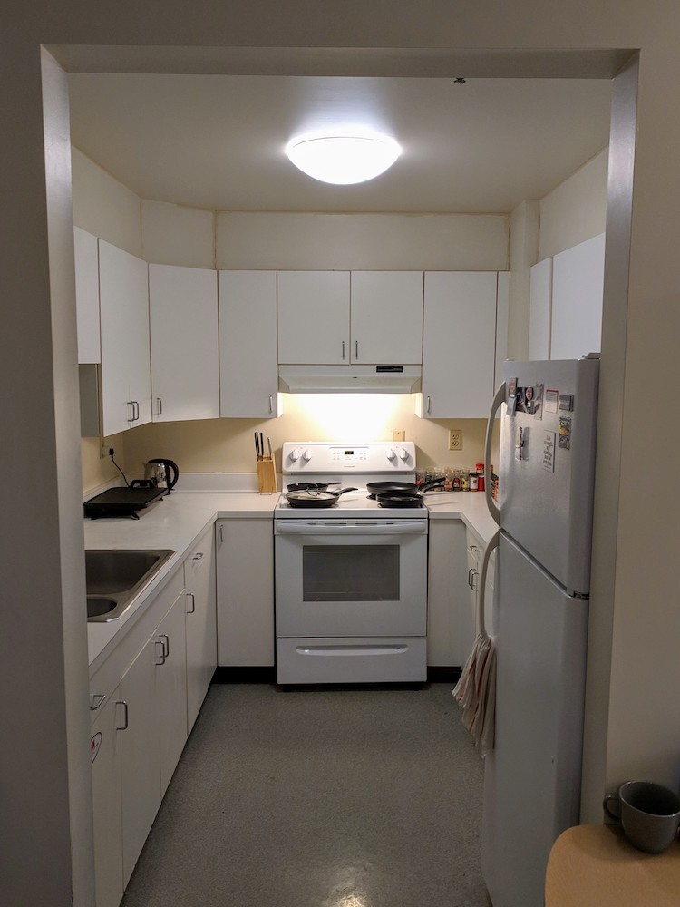 Apartment kitchen with appliances and cabinets